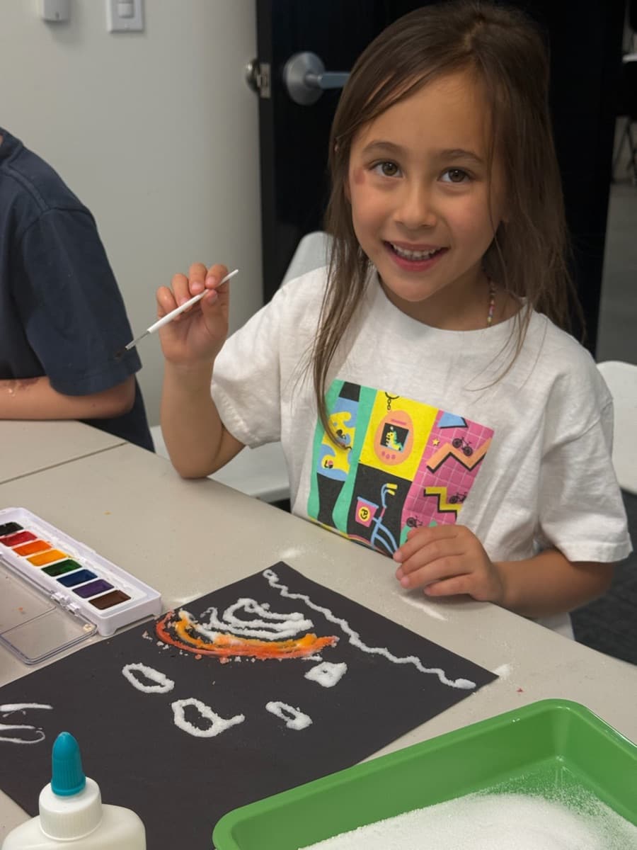 A child smiling during an art activity at our facility — Little Dreamers Preschool, Tigard Oregon